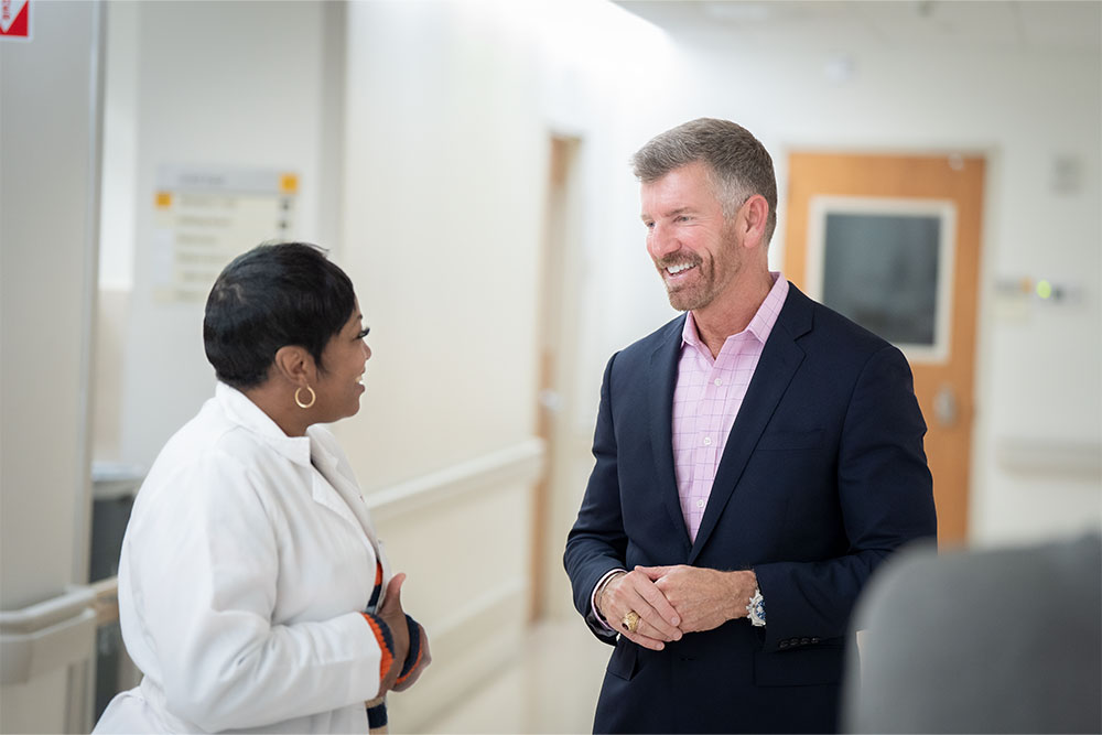 Marty Sargeant, CEO of Keck Medical Center of USC, talks with a health care provider.